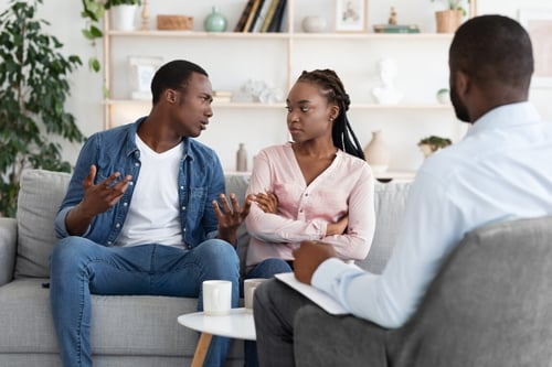 unhappy AfricanAmerican couple talking to counselor (Medium)